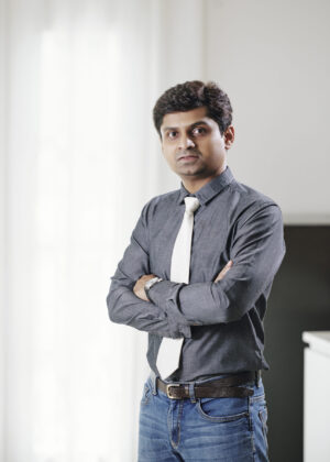 Serious business executive folding arms and looking at camera